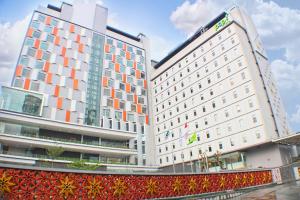 a large white building with orange squares on it at HARRIS Hotel & Conventions Solo in Solo