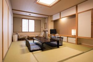 a room with a table and chairs in a room at Rusutsu Resort Hotel & Convention in Rusutsu