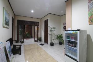 a room with a refrigerator with drinks in it at Pondok Muwa Guest House in Ubud