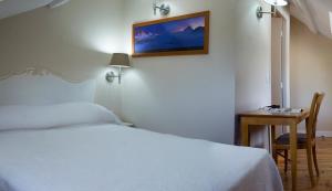 Postel nebo postele na pokoji v ubytování Hôtel Majestic