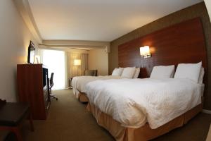 A bed or beds in a room at Budget Host Inn & Suites