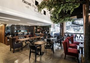 a restaurant with tables and chairs in a room at U Hotels Makati in Manila