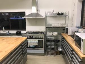 a kitchen with an oven and a stove top oven at Toreador Motel in Coffs Harbour