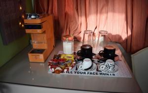 a table with cups and mugs on top of it at Adriana's Loft in Patra