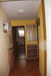 a hallway of a house with yellow walls at Vinný sklep u Konečků in Mikulčice