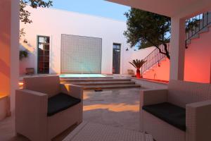 a house with a swimming pool and two chairs at La Casa del Mercante in Racale