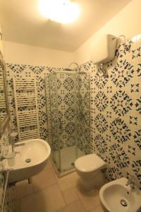 a bathroom with a sink and a toilet and a shower at La Casa del Mercante in Racale +13 photos