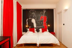 a bedroom with a bed with a poster on the wall at TRNAPT Torino Apartments in Turin