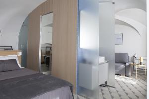 A bed or beds in a room at Genova Suite Art