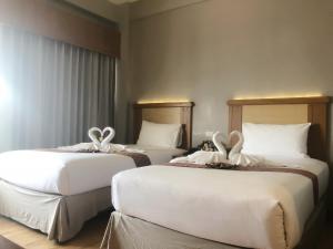 Postel nebo postele na pokoji v ubytování D-ONE Hotel