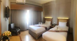 Postel nebo postele na pokoji v ubytování D-ONE Hotel