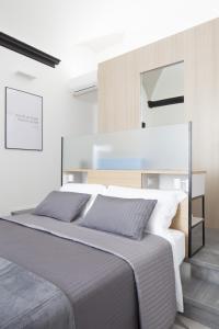 A bed or beds in a room at Genova Suite Art