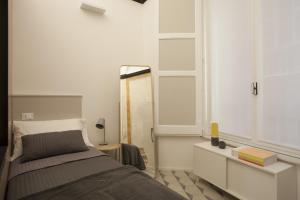 a bedroom with a bed and a mirror at Genova Suite Art in Genoa
