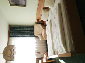 Postel nebo postele na pokoji v ubytování Hotel Garni