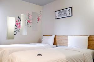 Postel nebo postele na pokoji v ubytování Izen Plus Budget Hotel & Residence