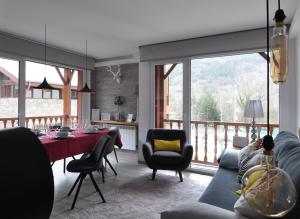 a living room with a table and a dining room at UP BENASQUE FLOR de NIEVE in Benasque