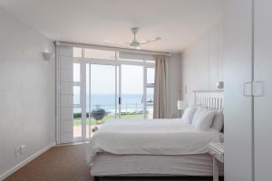 a bedroom with a bed with a view of the ocean at Suntrap 6 - FAMILY ONLY in Ballito
