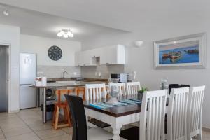 a kitchen and dining room with a table and chairs at Suntrap 6 - FAMILY ONLY in Ballito