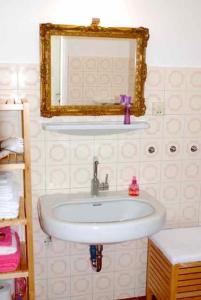 a bathroom with a sink and a mirror at Apartment Sternentor in Engerwitzdorf