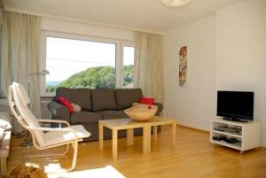 a living room with a couch and a table at Apartment Sternentor in Engerwitzdorf