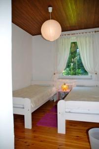 a bedroom with two beds and a window at Apartment Sternentor in Engerwitzdorf