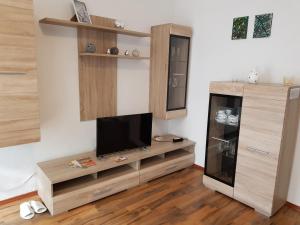 un soggiorno con TV su un centro di intrattenimento in legno di Privat Zimmer KF a Knittelfeld