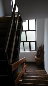 a staircase in a room with a large window at S&G Apartment in Vranje