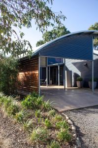 a modern house with a blue roof at Corrugated Cottage in Dunkeld