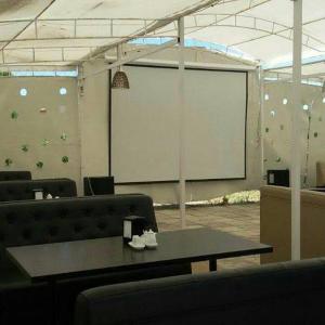 a conference room with a large screen and a table at Bely Parus in Bosteri