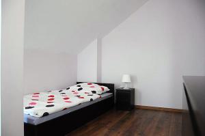a bedroom with a bed with apples on it at Apartamenty Adrenja in Rowy