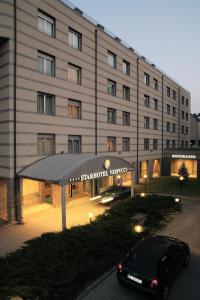 a car parked in front of a building at Starhotels Vespucci in Campi Bisenzio