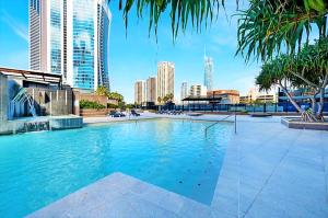 a large swimming pool in a city with tall buildings at Circle on Cavil Holidays Gold Coast in Gold Coast