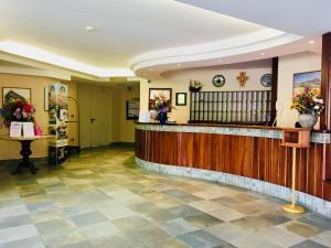 a hotel lobby with a reception counter and flowers at Grand Hotel L'Approdo in Terracina