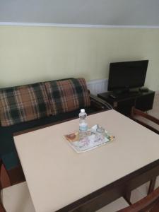 a table with a bottle of water on top of it at Inter Hotel in Ternopilʼ