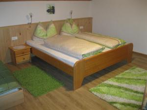 a wooden bed with two pillows on it in a room at Rossruckhof in Rohrberg