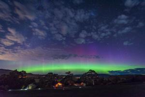 an aurora in the sky over a city at night at Truffle Lodge Dinner Bed Breakfast Glamping in Gretna