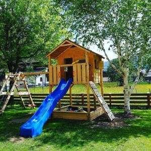 a playground with a slide and a play house at Haus Fercher in Grossarl