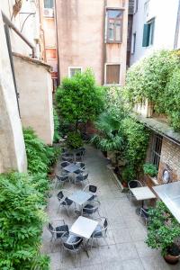 a patio area with tables, chairs and umbrellas at Fujiyama B & B in Venice