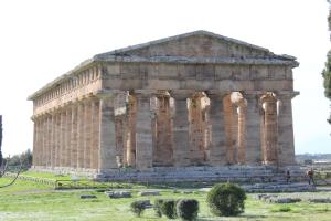 a large stone building with columns in a field at B&B Menta e Limone in Paestum