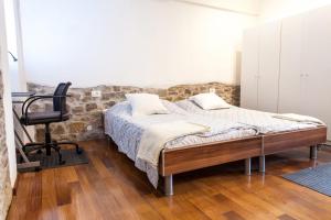 a bedroom with a bed and a chair at Naja's apartments (apartment 1) in Koper