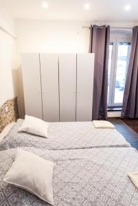 a bedroom with two beds with white cabinets at Naja's apartments (apartment 1) in Koper