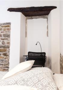 a bedroom with a bed and a stone wall at Naja's apartments (apartment 1) in Koper