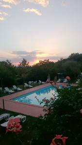 a view of a swimming pool at sunset at Locanda Delle Noci in Perugia