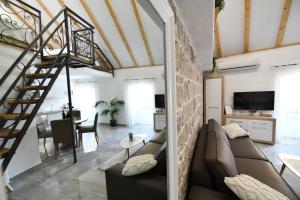 a living room with a couch and a staircase at Apartment Lavanda in Sinj