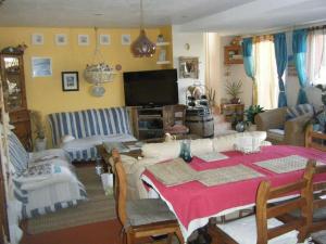 a living room with a table and a couch at Anne et Billy in Le Relecq-Kerhuon