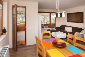 a living room and dining room with a table and chairs at Апартамент "Forest view" в комплекс "Вели Хилс" in Velingrad
