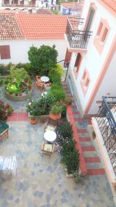 an overhead view of a courtyard with tables and benches at Green Hill Studios & Apartments in Kokkari