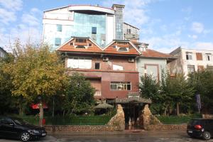 a large building with a car parked in front of it at Hotel Bar Restaurant America in Kukës