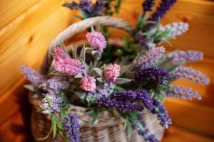 a basket filled with purple and pink flowers at Penzion Šterk in Most na Soči