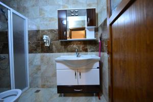 a bathroom with a sink and a mirror at Kuloğlu Apart 2 in Uzungöl +29 photos